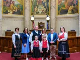 Sen. Spreitzer and Rep. Jacobson stand in the Senate Chamber with constituents at the annual Capitol Syttende Mai celebration. 