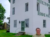 Sen. Spreitzer stands in front of Milton House Museum, a historic stop on the Underground Railroad.