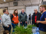 Sen. Spreitzer, Rep. Jacobson, DATCP Secretary Randy Romanski, and Governor Evers speak with a constituent at a farm in the 15th Senate District. 