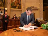Sen. Spreitzer signs the oath of office book. 