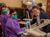 Sen. Spreitzer smiles with students learning about dental health at Blackhawk Technical College.   