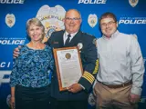 Sen. Spreitzer and Rep. Conley present a legislative citation to retiring Janesville Police Chief David Moore. 