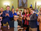 Sen. Spreitzer and others applaud as Governor Tony Evers signs 2023 Wisconsin Act 123 into state law. 