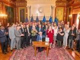 Sen. Spreitzer and other legislators clap as Governor Tony Evers signs a housing bill into state law. 