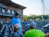 Sen. Spreitzer speaks with constituents at a Beloit Sky Carp game. 