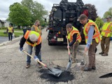 Sen. Spreitzer, Governor Tony Evers, and City Manager Kevin Lahner fill potholes in Janesville. 