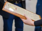 A woman holds a legislative citation presented by Sen. Spreitzer.