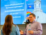Sen. Spreitzer speaks with a Wisconsinite at the 2024 Rock County LGBTQ+ Summit. 