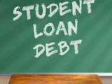 A cartoon graphic of a classroom with a desk and chalkboard. On the board, the words "Student Loan Debt" are written at a slight angle.