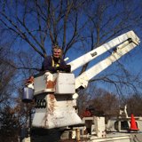 Senator Smith in the bucket of the truck for his window cleaning business.