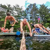 Action photo of people jumping into a lake from a dock with a go-pro.