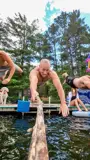 Action photo of people jumping into a lake from a dock with a go-pro.