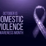 A poster with an illustration of a purple ribbon and the words "October is Domestic Violence Awareness Month".