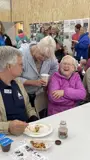 Constituents laugh alongside Senator Smith while enjoying breakfast at the Pepin County Dairy Breakfast in 2024.