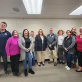 Senator Smith posing with Western Dairyland Child Care Partnership staff