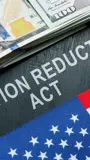 Clipart of a dollar bill, a partial American flag, and the words "Inflation Reduction Act. 