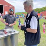 Senator Smith gets a cup of Culvers custard from a food cart at the Eau Claire Dairy Breakfast.