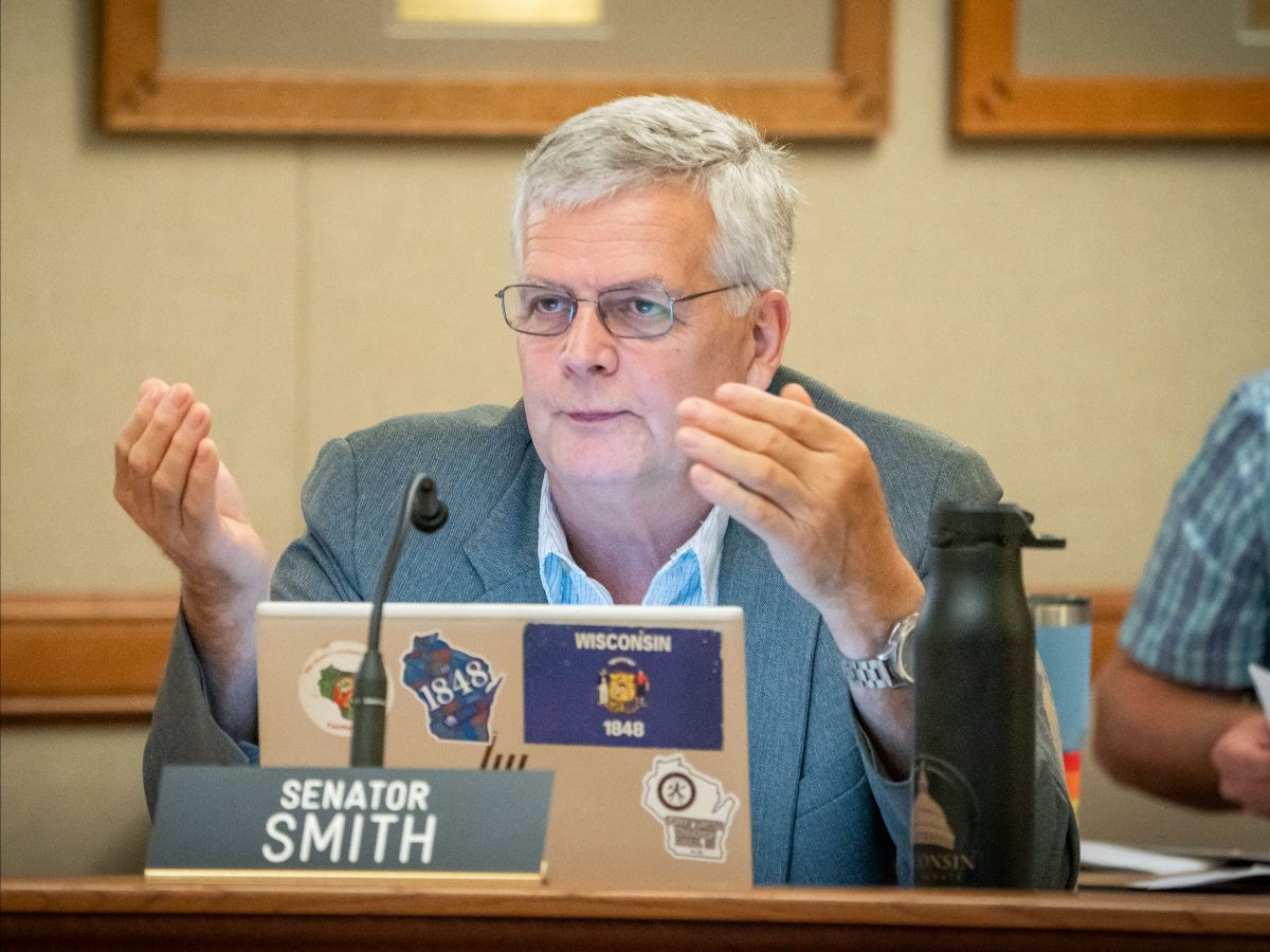Senator Smith speaks to a member of the public giving testimony at the August 23rd meeting of the Senate Committee on Universities and Revenue