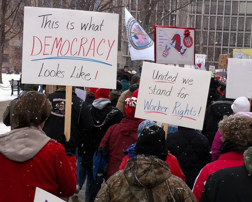 Protesters in favor of unions demonstrate in front of the Wisconsin State Capitol building
