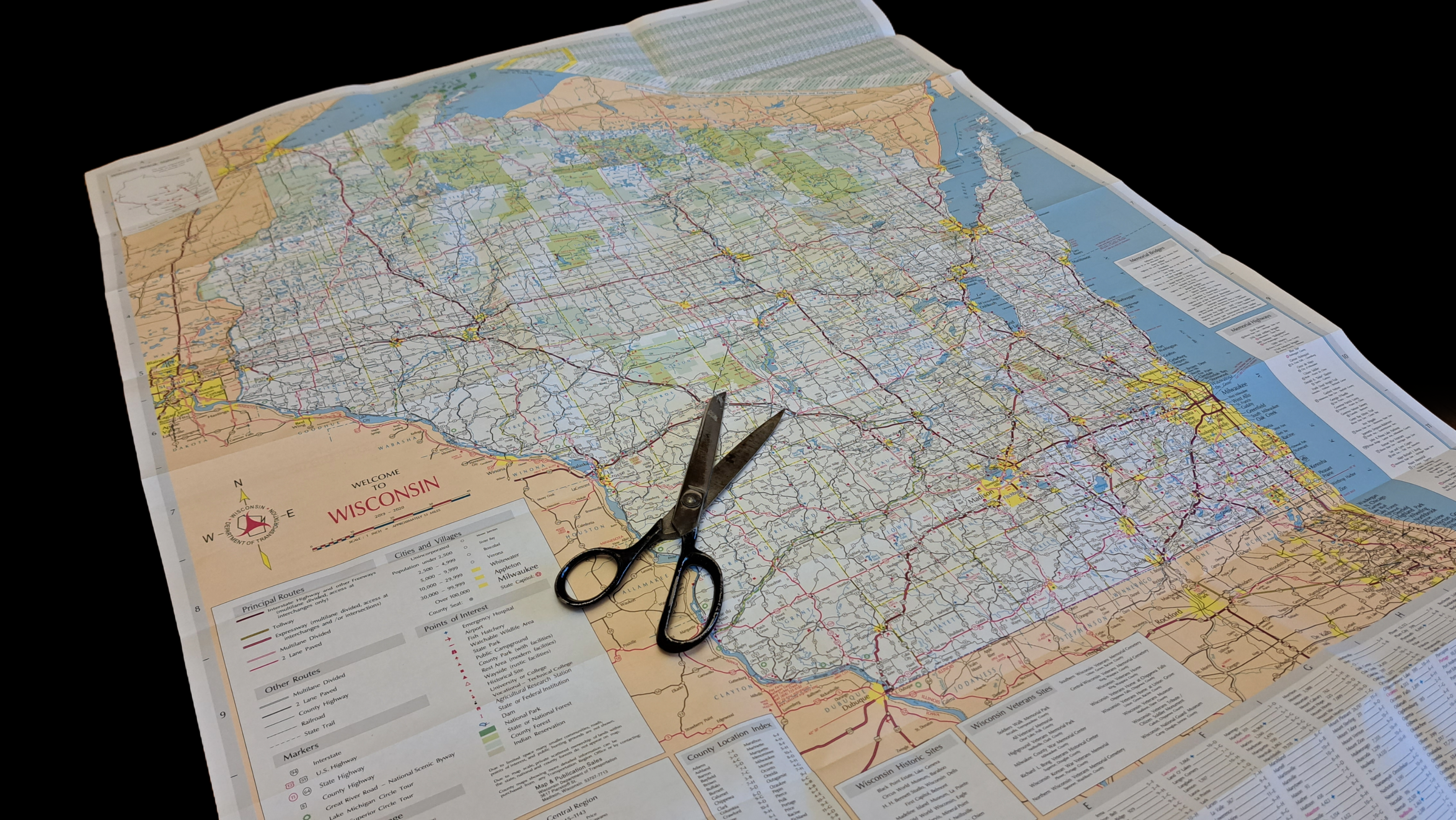 A map of Wisconsin with a pair of scissors