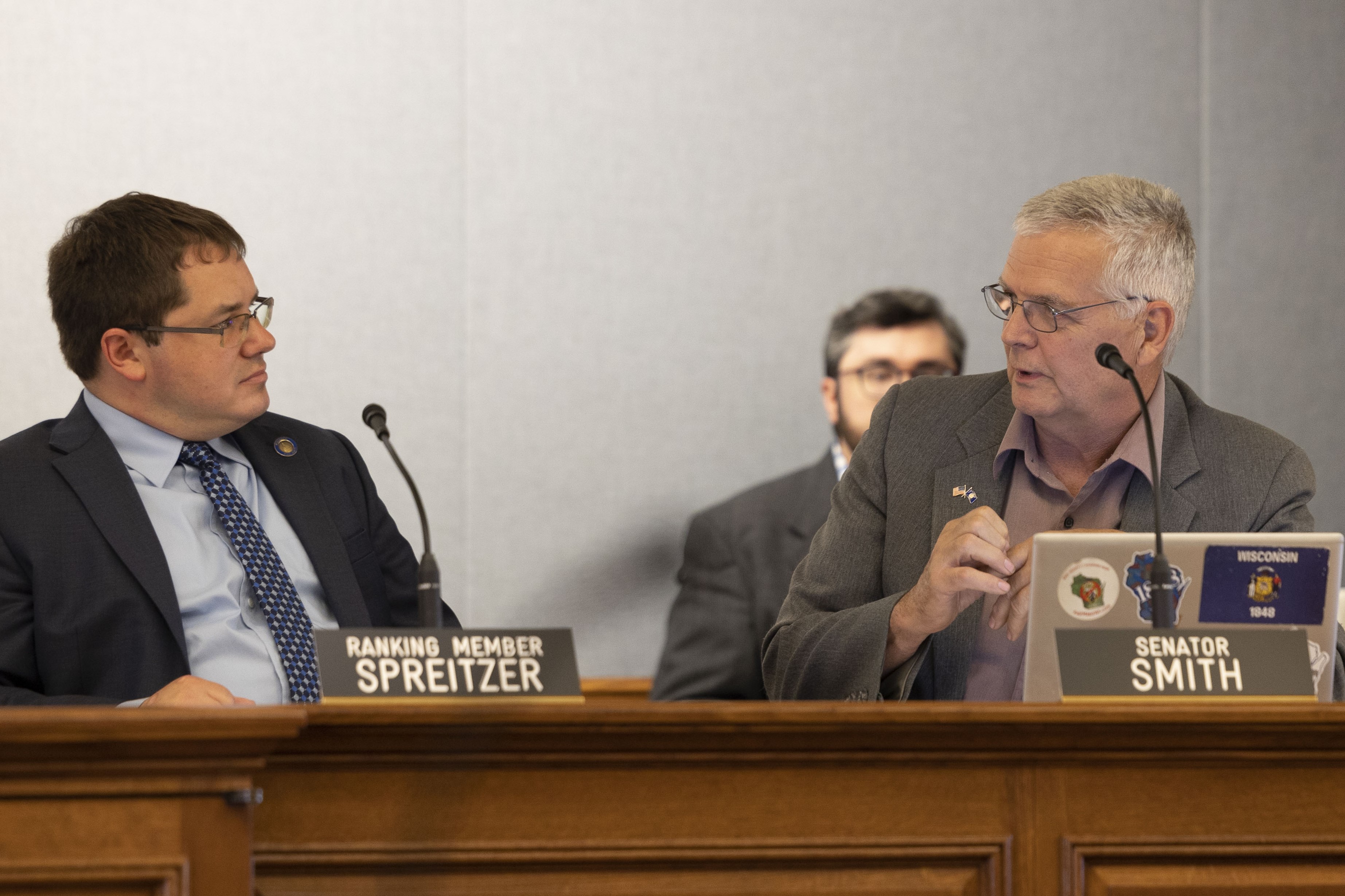 Senator Jeff Smith and Senator Mark Spreitzer speak at a committee hearing for the Senate Committee on Shared Revenue, Elections and Consumer Protection.