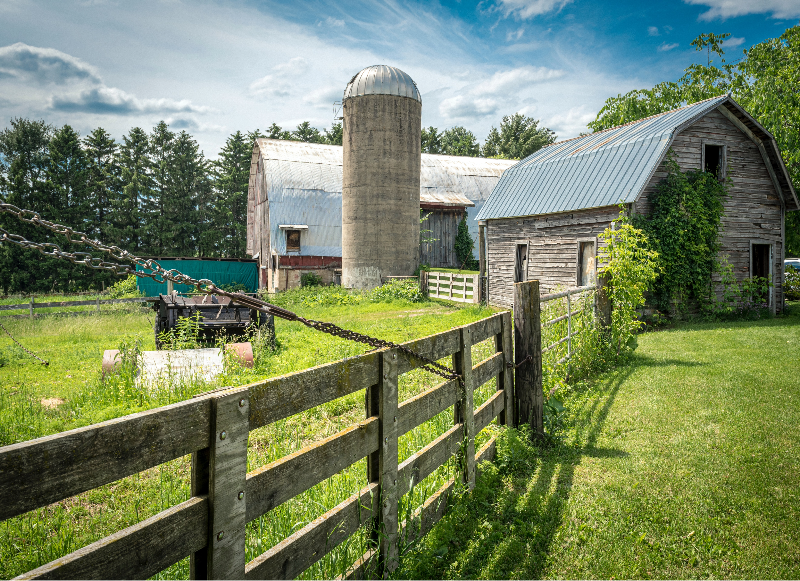 An old farm with a barn and a silo