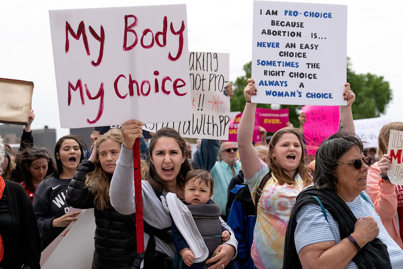 Protesters hold signs in support of reproductive rights