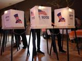 Three voting booths on a stage.