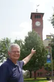 Senator Smith pointing at the clock tower at the University of Wisconsin-Stout.